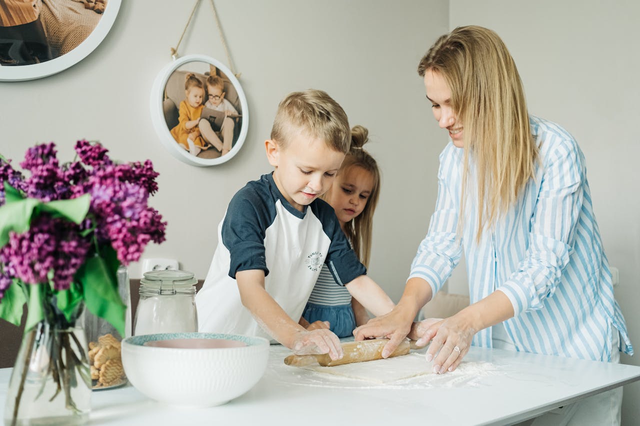 gallery-6 Mother and children enjoying a fun and messy baking session together at home.