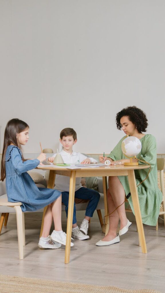 A teacher engages young students in classroom activities, promoting learning and interaction.