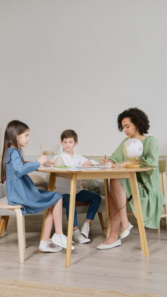 A teacher engages young students in classroom activities, promoting learning and interaction.